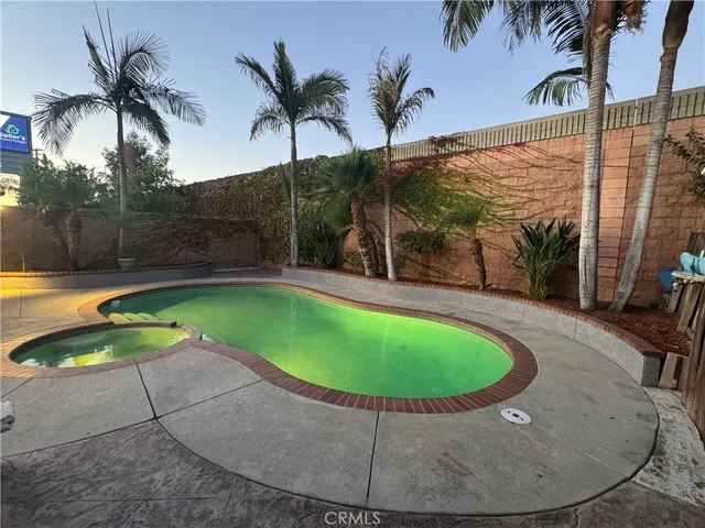 a view of a swimming pool with a yard
