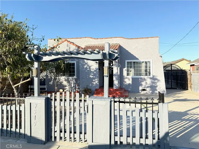 a view of a house with wooden fence