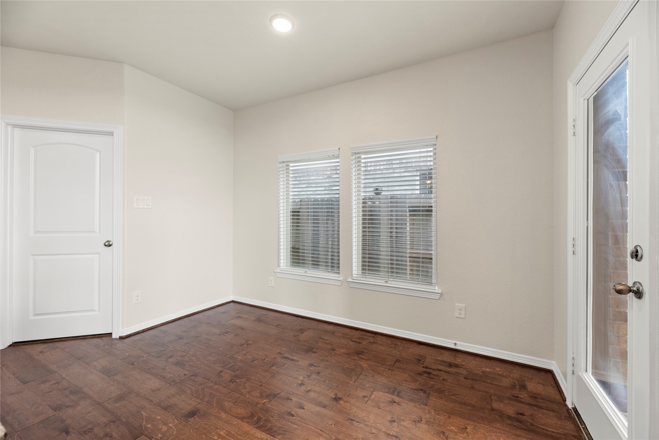 11734 Deepwater Ridge Way Cypress, TX 77433 - Photo 12 of 35 an empty room with wooden floor and windows