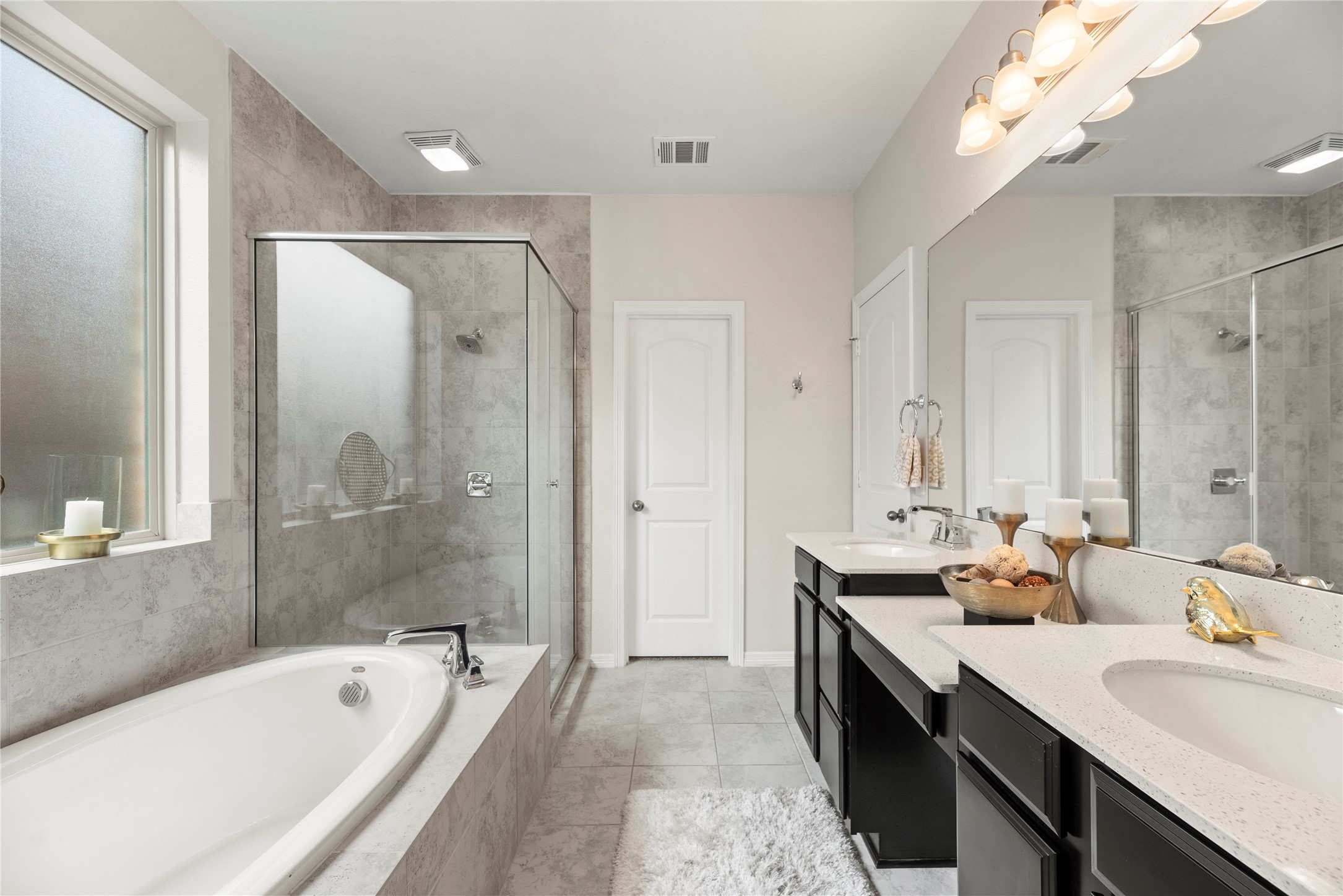 11734 Deepwater Ridge Way Cypress, TX 77433 - Photo 17 of 35 a bathroom with a tub a sink double vanity and a mirror