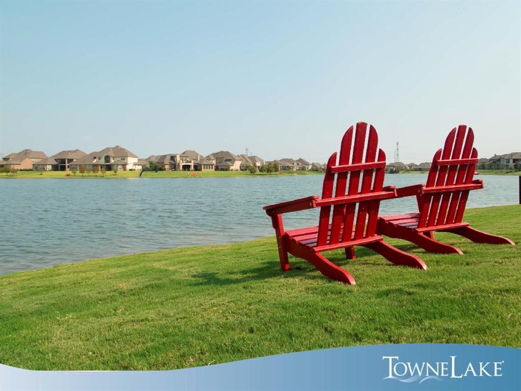 11734 Deepwater Ridge Way Cypress, TX 77433 - Photo 33 of 35 a view of a lake with a mountain in the background