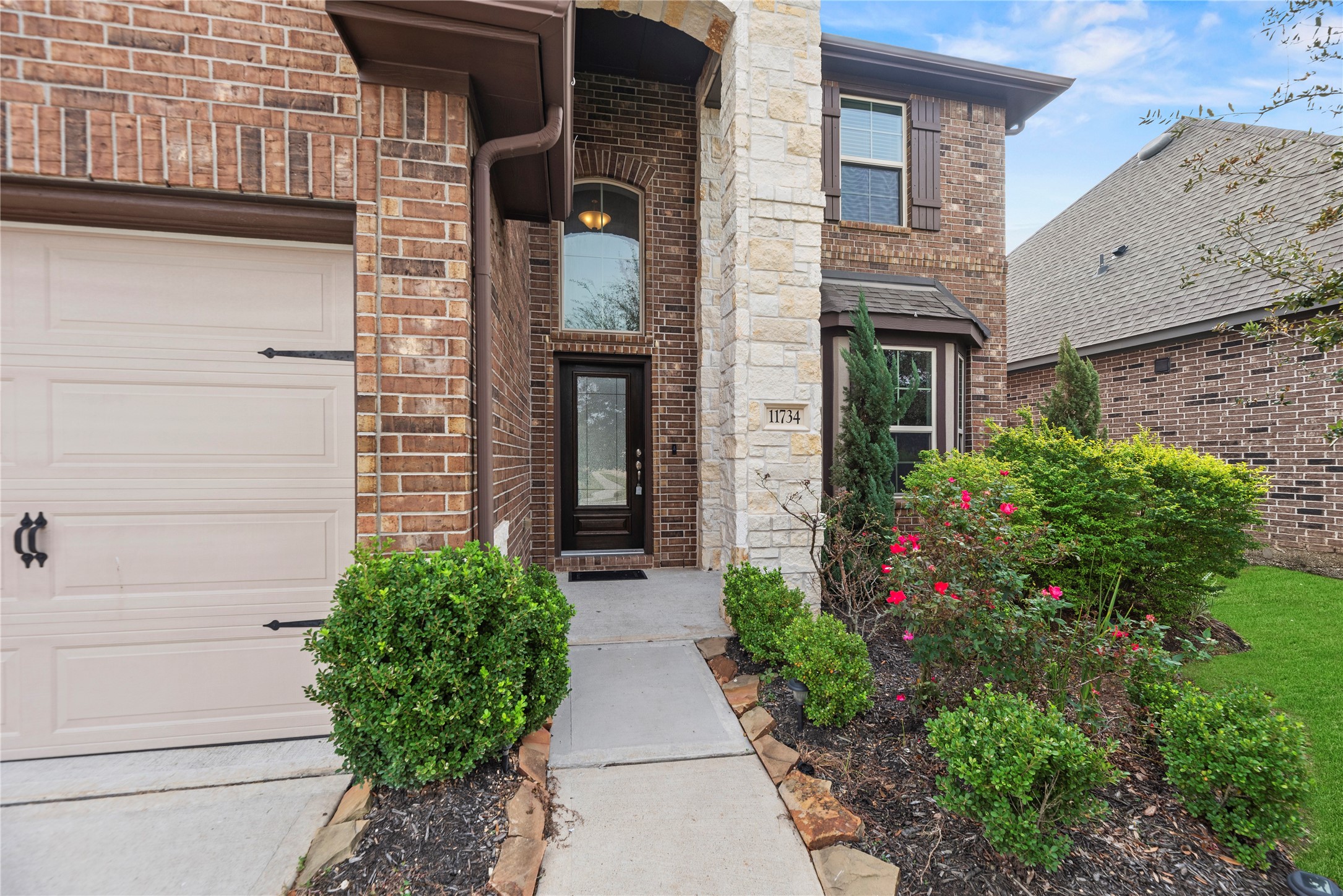 11734 Deepwater Ridge Way Cypress, TX 77433 - Photo 4 of 35 a house with potted plants in front of door