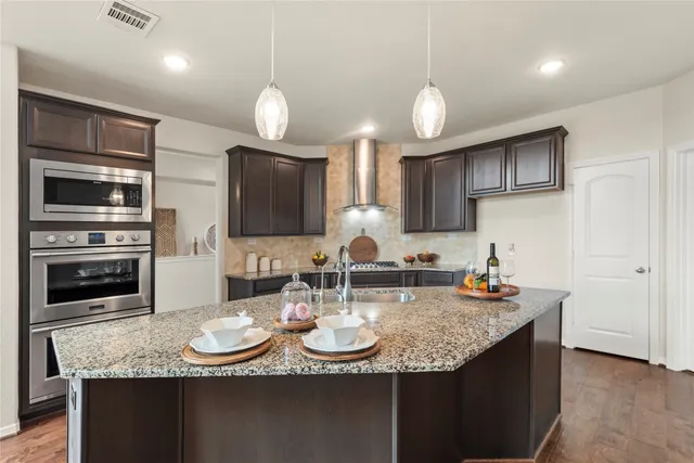 a kitchen with sink dining table and chairs