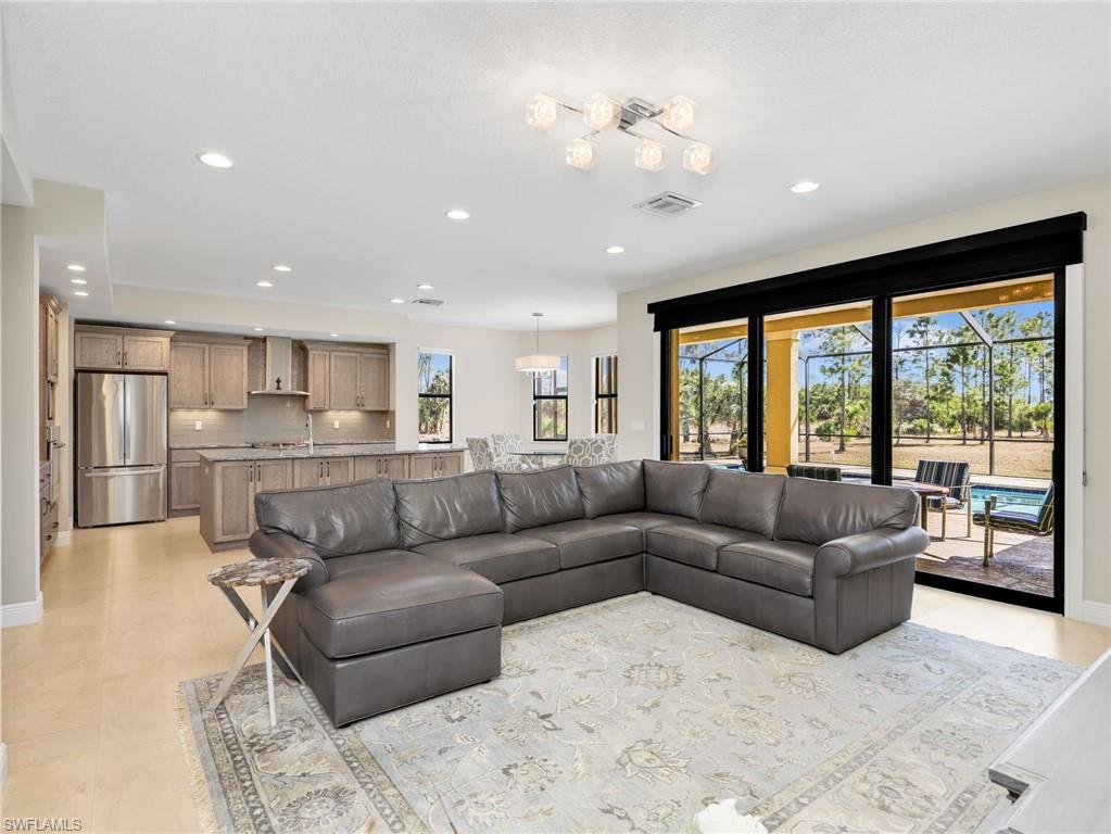 3160 27th Avenue Southwest Naples, FL 34117 - Photo 15 of 43 a living room with furniture and a large window