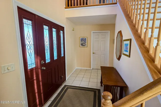 a bedroom with a bed and a mirror on dresser