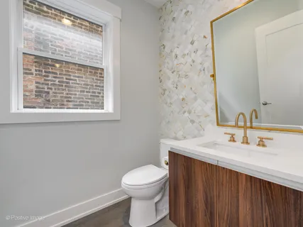 a bathroom with a sink a toilet and a window