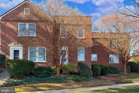 a front view of a brick house with a yard