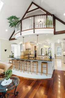 a view of a hallway with a dining table chairs a chandelier