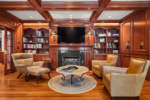 an outdoor living room with furniture and a floor to ceiling window