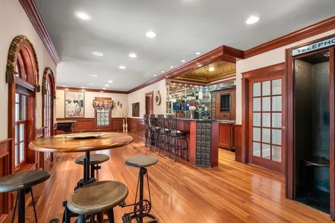 a large bathroom with a granite countertop double vanity sink a bathtub and window