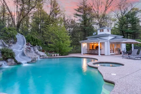 a kitchen view with a large window and outdoor seating