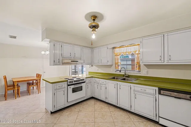 a kitchen with stainless steel appliances granite countertop a sink and cabinets