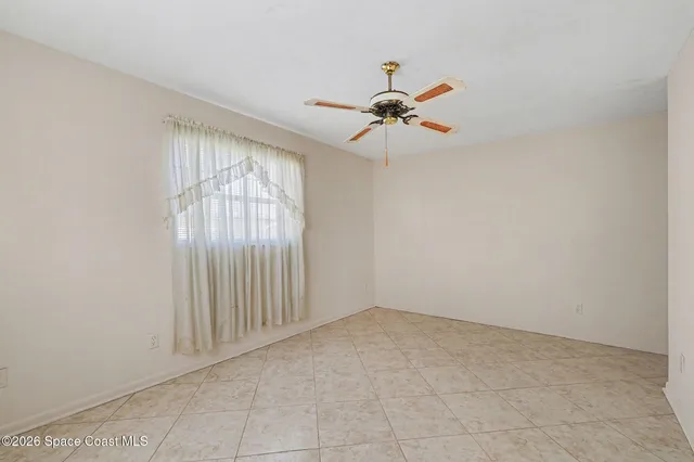 a view of room with hardwood floor and ceiling fan