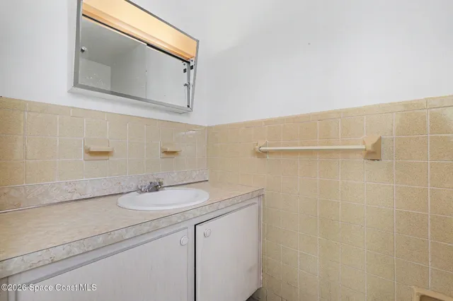 a bathroom with a sink a vanity and a mirror