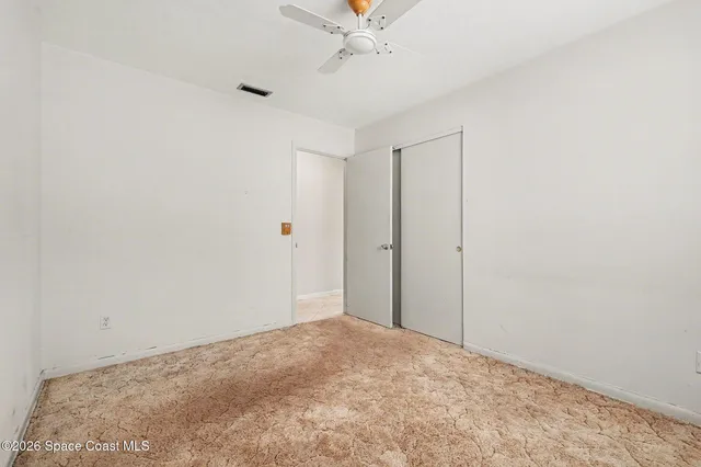 a view of a room with a ceiling fan