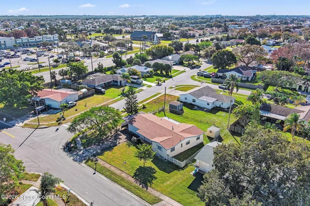 an aerial view of residential houses with outdoor space