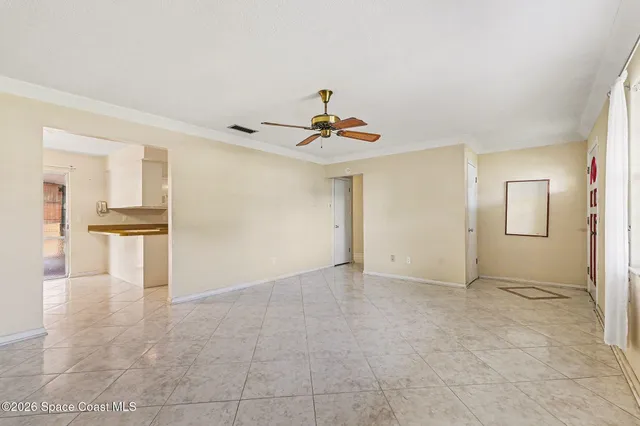 a view of a livingroom with wooden floor and a ceiling fan
