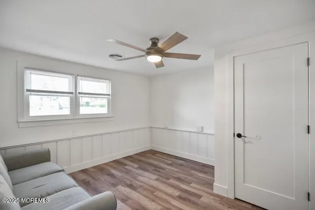 a view of a hallway with wooden floor and entryway