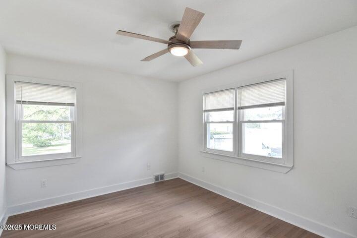 7 Kaylen Place Hazlet, NJ 07730 - Photo 19 of 22 an empty room with wooden floor ceiling fan and windows