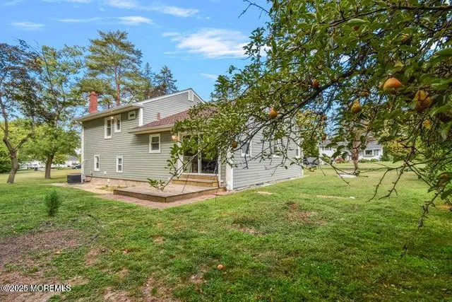 a view of a backyard with large trees