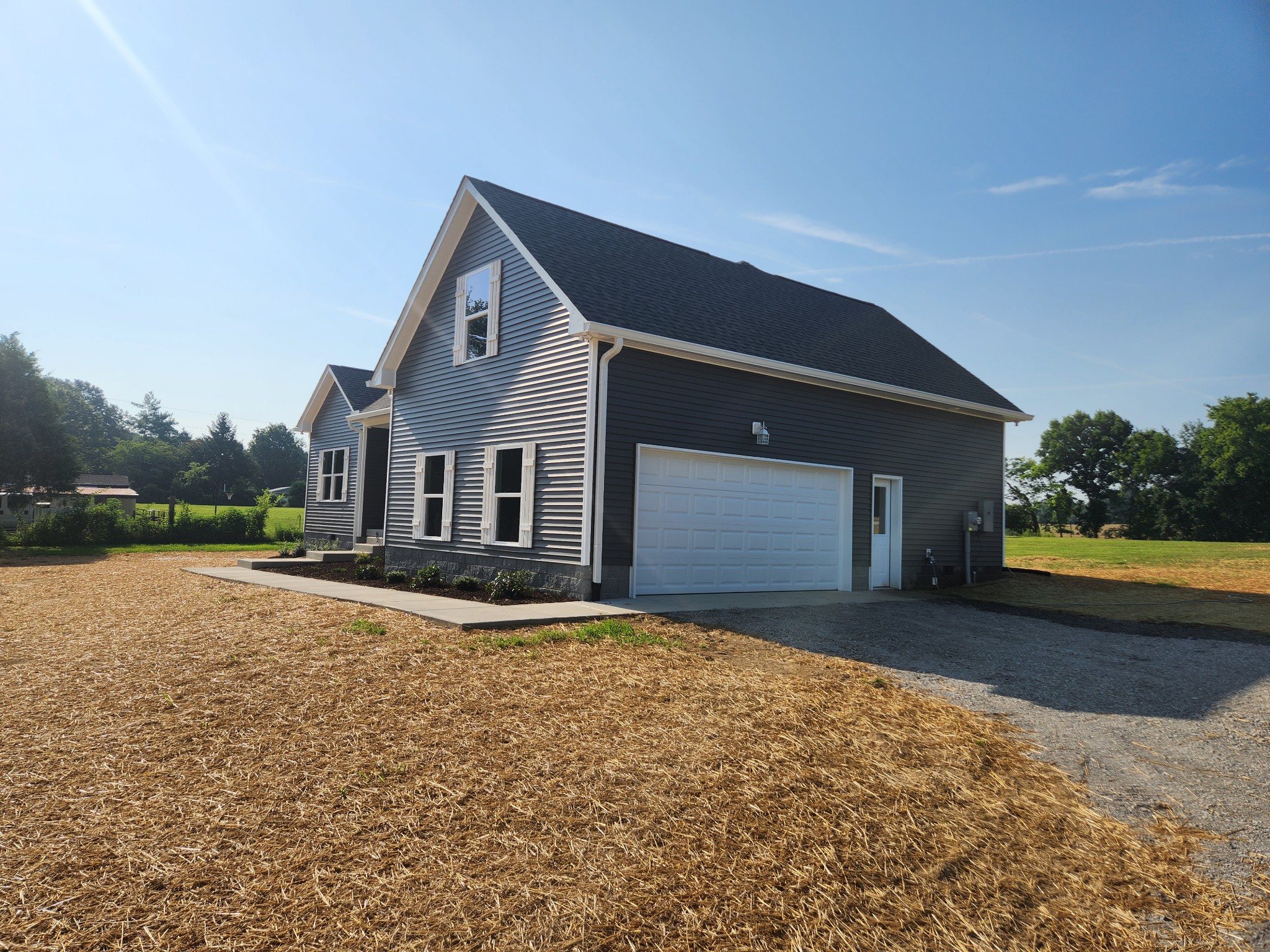 7687 Covington Road White House, TN 37188 - Photo 2 of 16 a front view of a house with a yard and garage