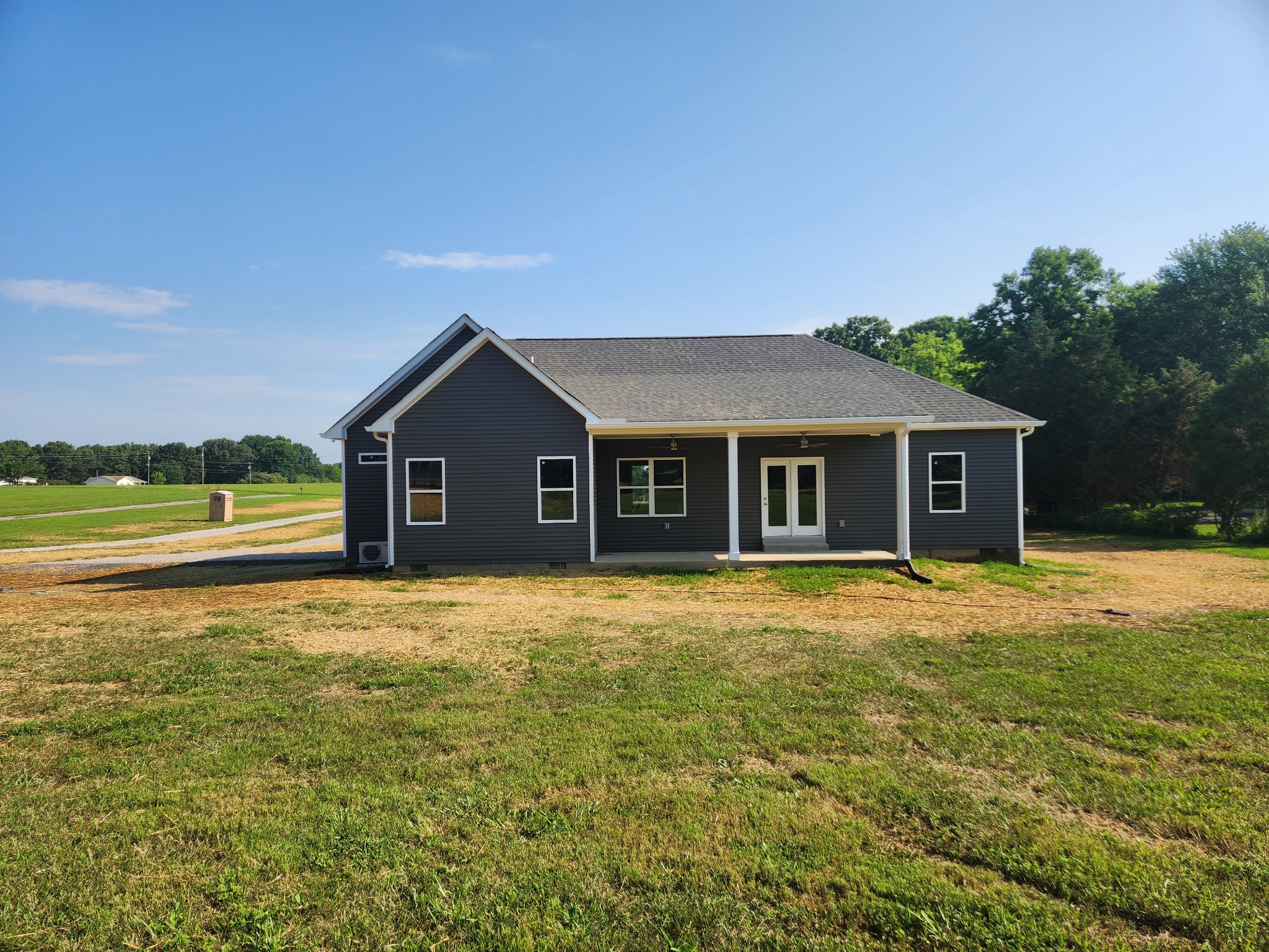 7687 Covington Road White House, TN 37188 - Photo 3 of 16 a front view of a house with a yard and garage