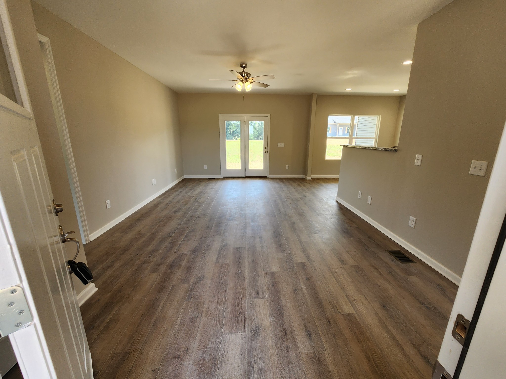 7687 Covington Road White House, TN 37188 - Photo 5 of 16 wooden floor in an empty room with a window