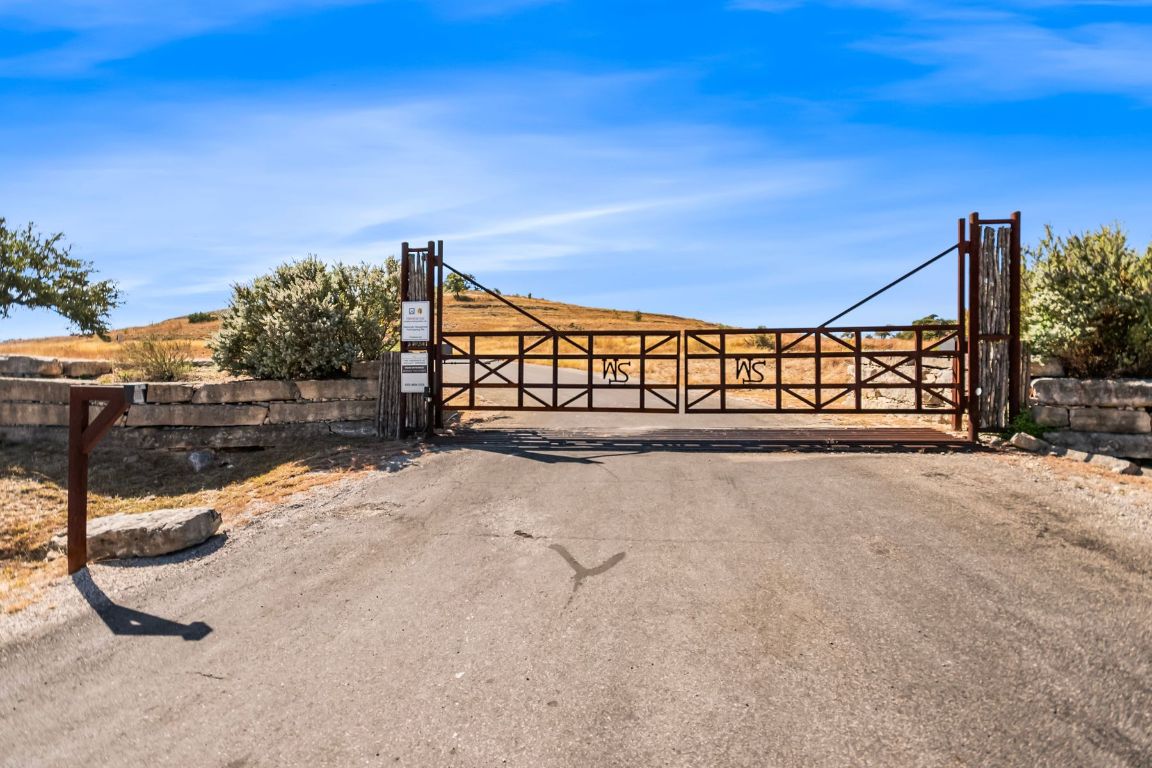 226 South Walnut Springs Road Johnson City, TX 78636 - Photo 18 of 26 a view of a pathway with a wrought fence