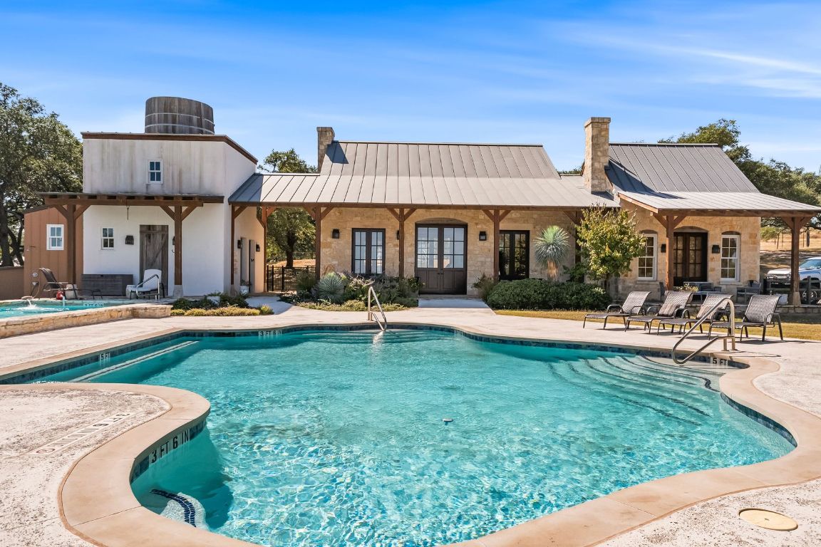 226 South Walnut Springs Road Johnson City, TX 78636 - Photo 24 of 26 a view of a house with swimming pool and sitting area