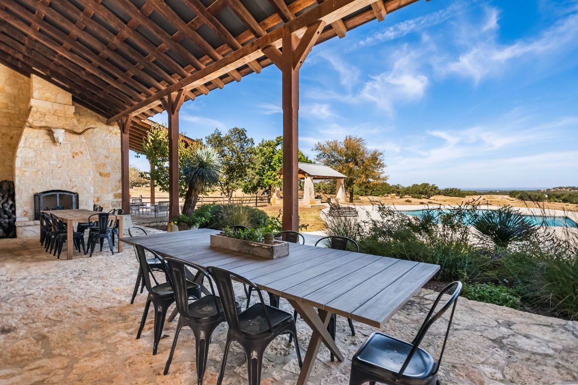 226 South Walnut Springs Road Johnson City, TX 78636 - Photo 26 of 26 a view of a patio with a table and chairs and a barbeque