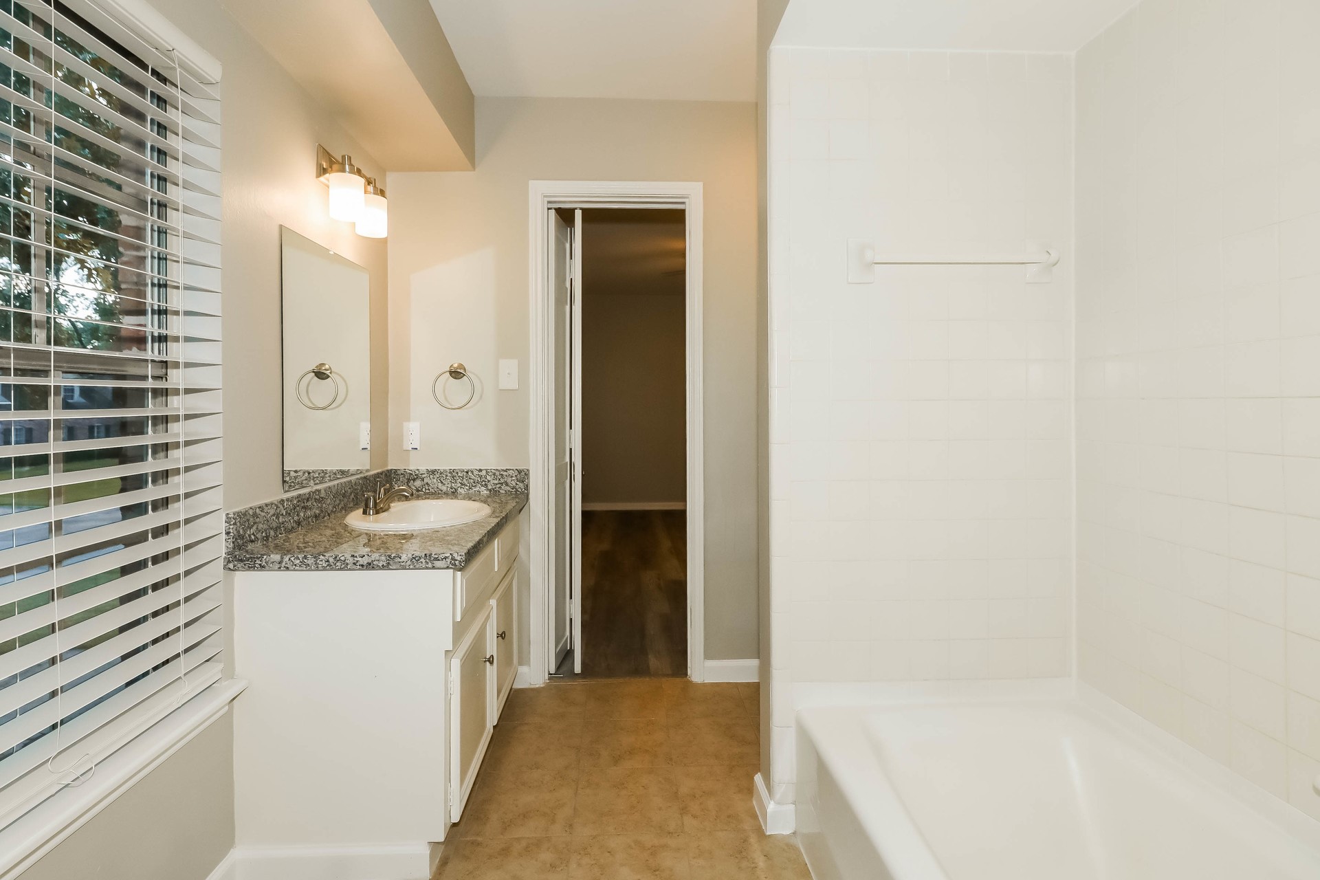 1506 Castlerock Road Houston, TX 77090 - Photo 17 of 23 a bathroom with a granite countertop sink and a mirror