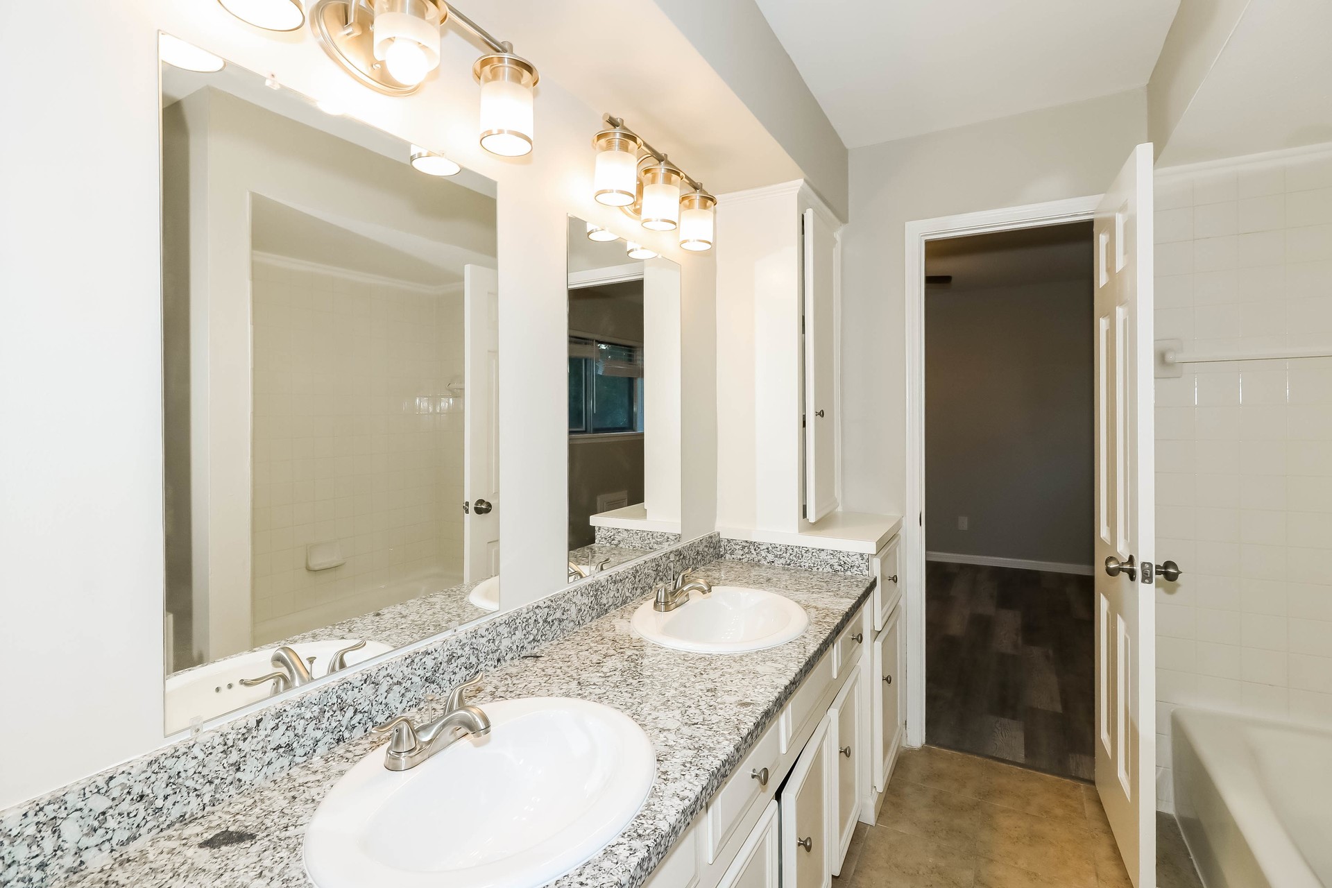 1506 Castlerock Road Houston, TX 77090 - Photo 18 of 23 a bathroom with a granite countertop sink and a mirror