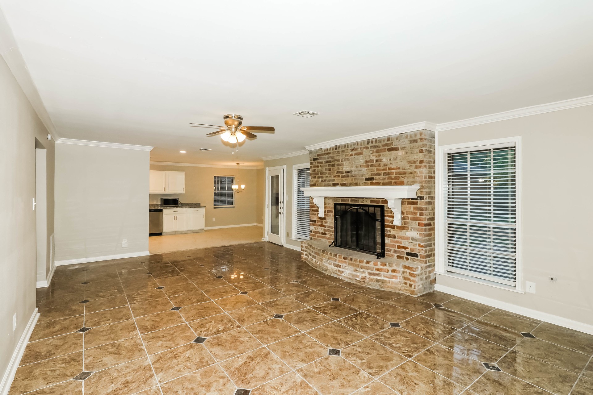 1506 Castlerock Road Houston, TX 77090 - Photo 3 of 23 a view of an empty room with a fireplace and a window
