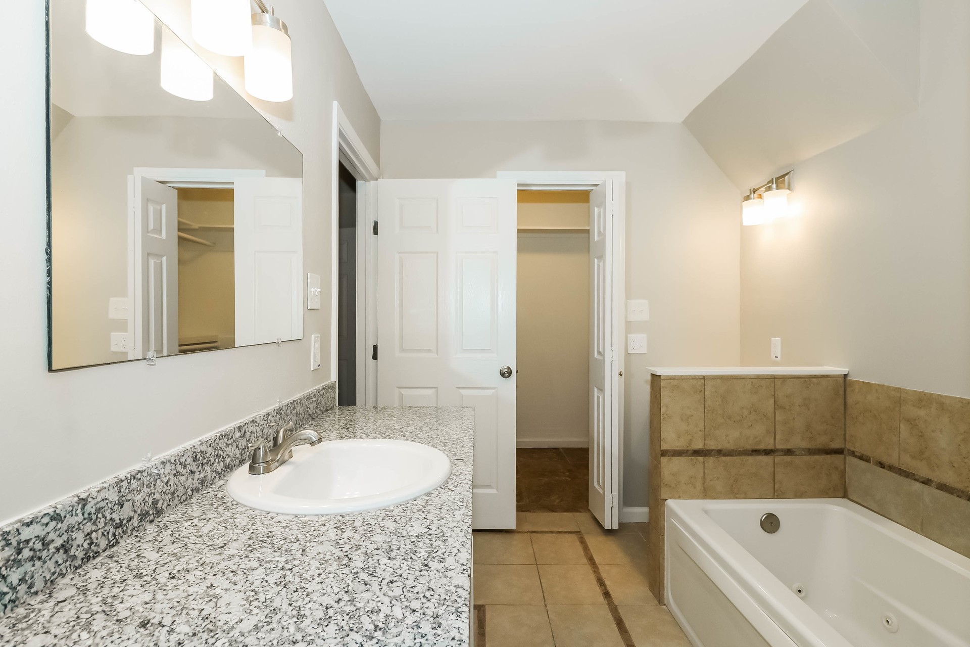 1506 Castlerock Road Houston, TX 77090 - Photo 10 of 23 a bathroom with a tub sink and mirror
