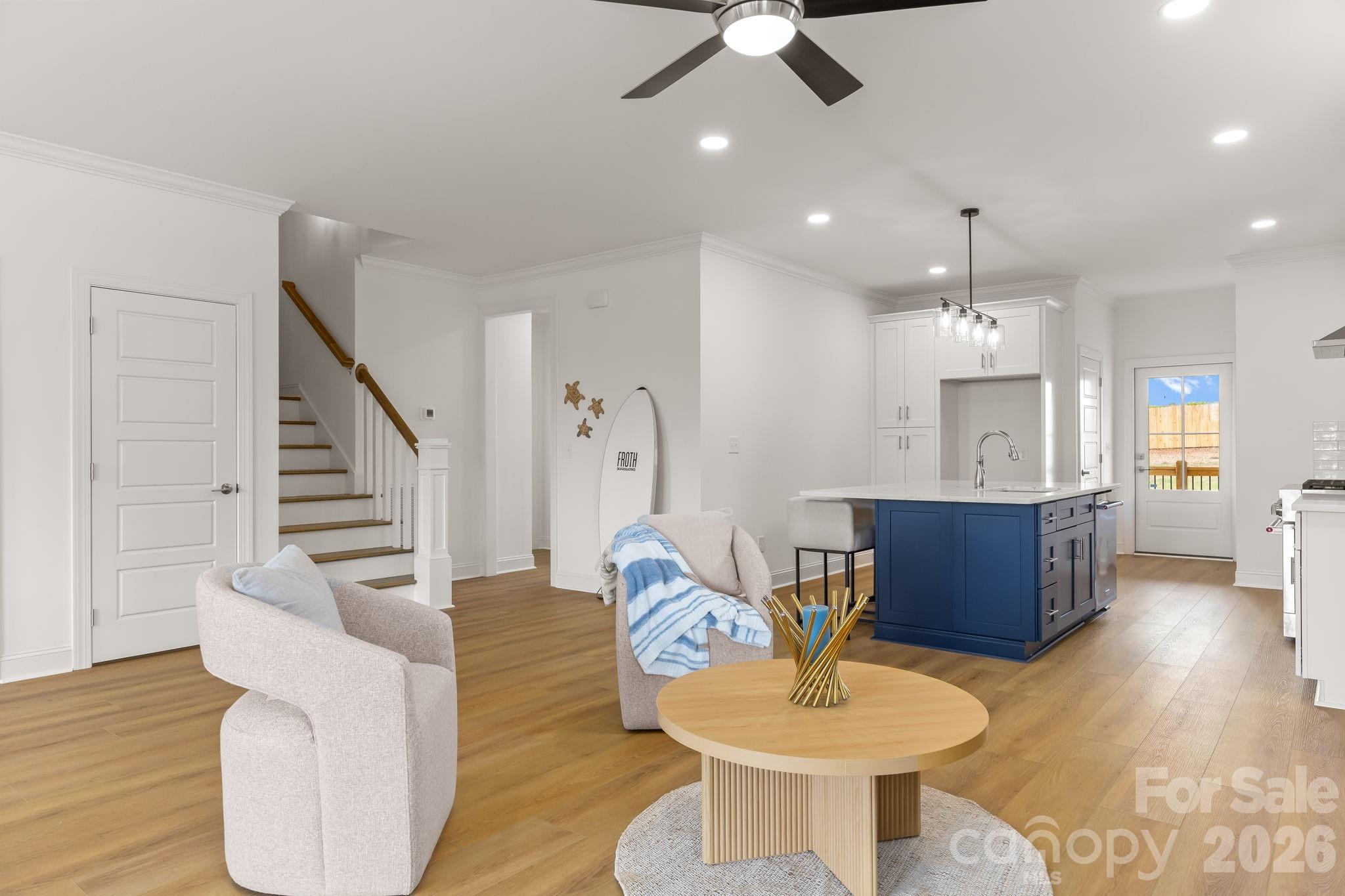 8078 Blackwood Road Denver, NC 28037 - Photo 14 of 48 a living room with furniture a dining table and a chandelier