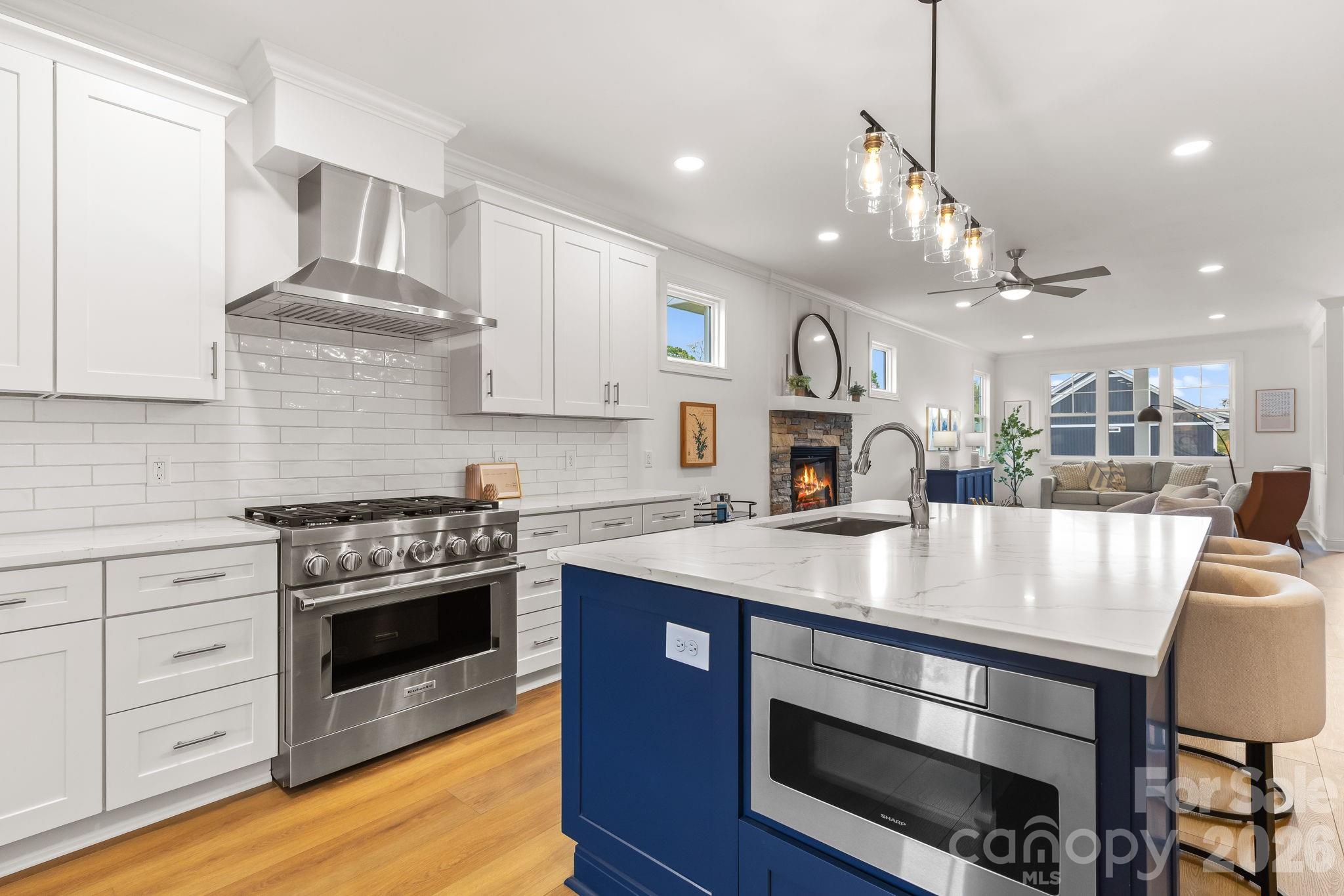8078 Blackwood Road Denver, NC 28037 - Photo 20 of 48 a kitchen with kitchen island a stove a table and chairs