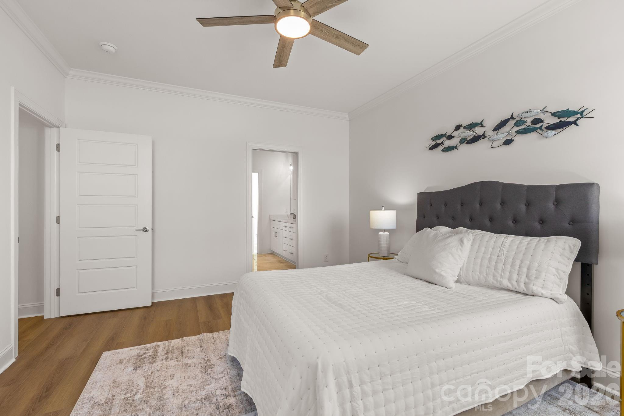 8078 Blackwood Road Denver, NC 28037 - Photo 25 of 48 a bedroom with a bed and a ceiling fan