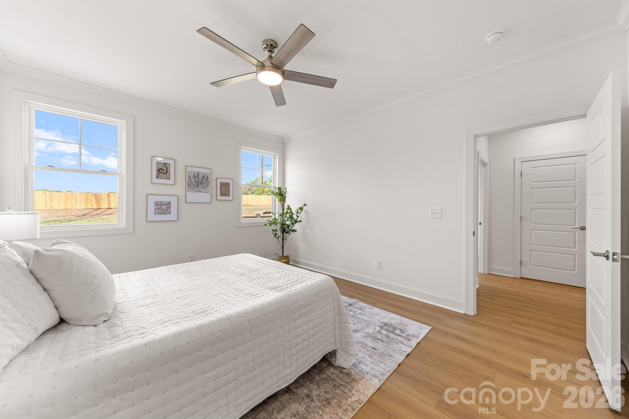 8078 Blackwood Road Denver, NC 28037 - Photo 26 of 48 a bedroom with a large bed and wooden floor