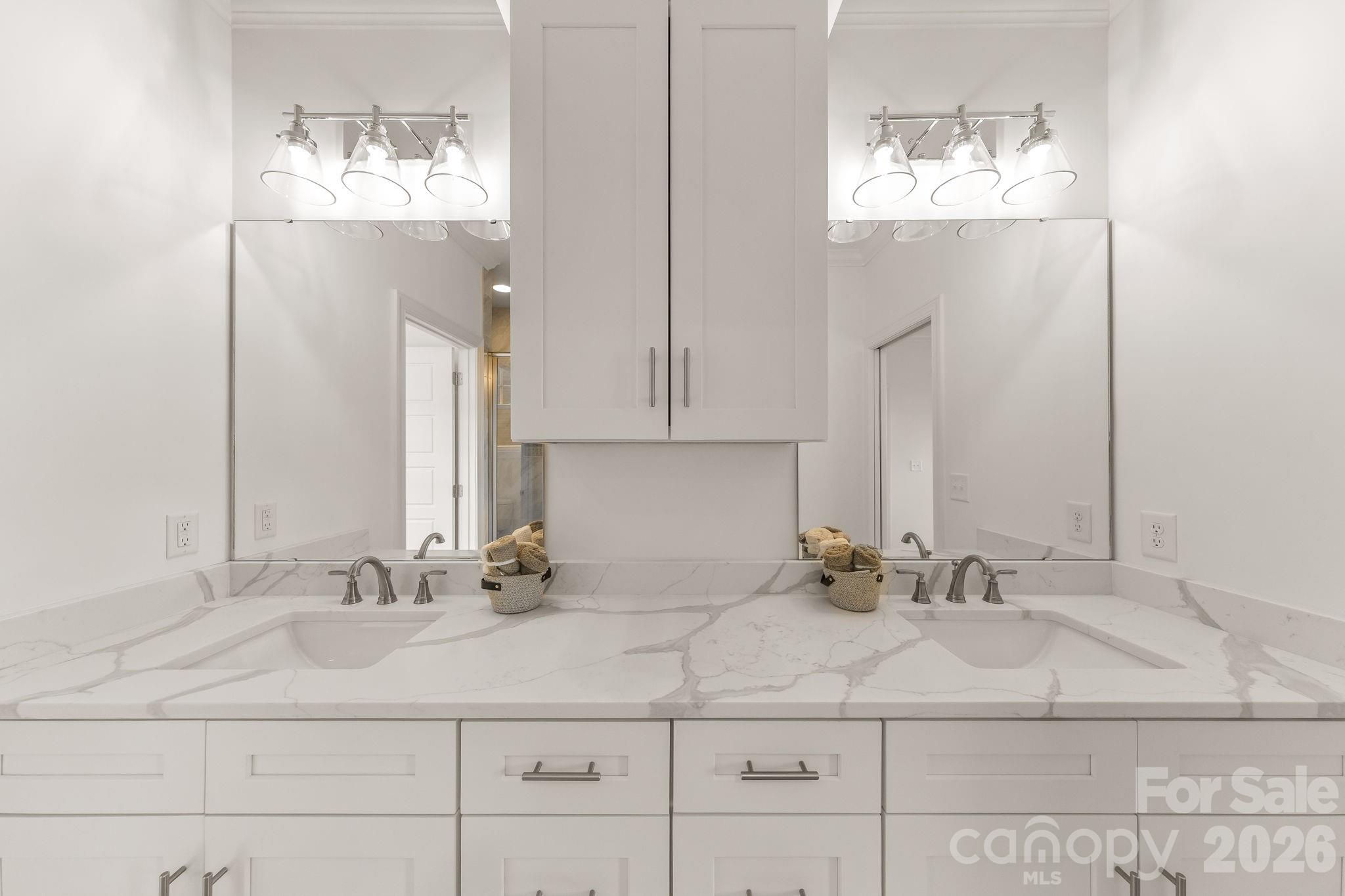 8078 Blackwood Road Denver, NC 28037 - Photo 30 of 48 a bathroom with double vanity sinks and a mirror