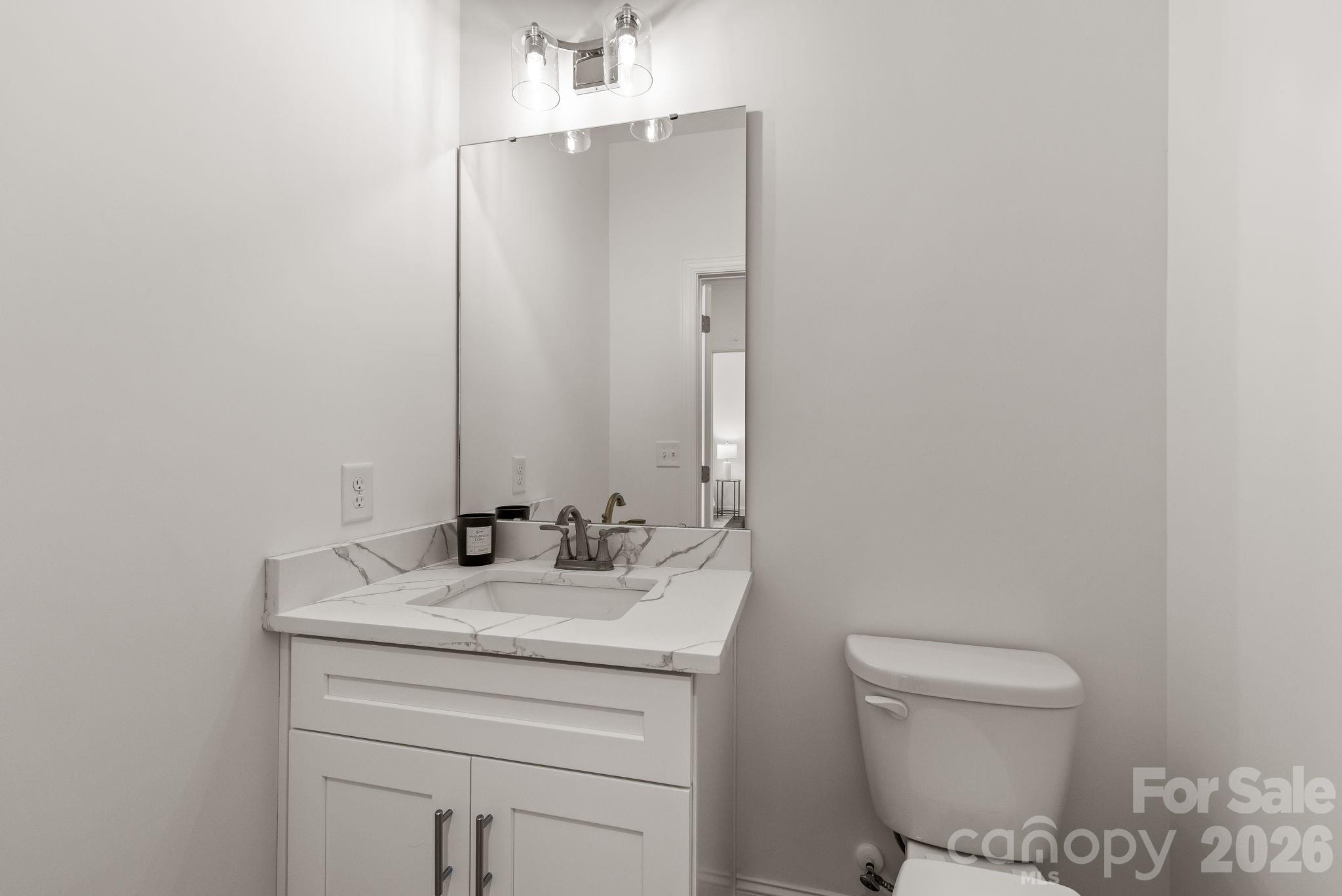8078 Blackwood Road Denver, NC 28037 - Photo 32 of 48 a bathroom with a sink toilet and mirror
