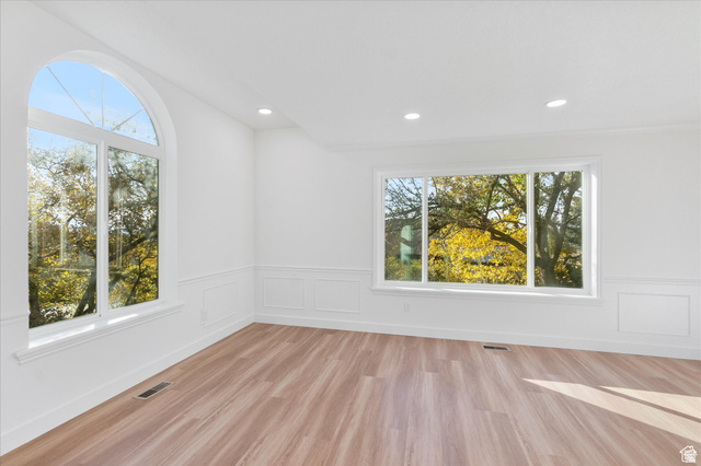 2078 Spring Oaks Drive Springville, UT 84663 - Photo 12 of 40 Empty room featuring light wood finished floors, recessed lighting, and wainscoting