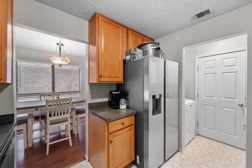 1312 Hackamore Street Mesquite, TX 75149 - Photo 12 of 28 a kitchen with a refrigerator and a sink