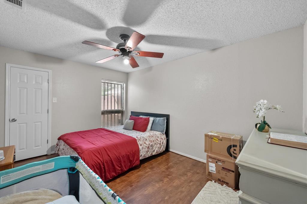 1312 Hackamore Street Mesquite, TX 75149 - Photo 21 of 28 a bedroom with a bed and a chandelier