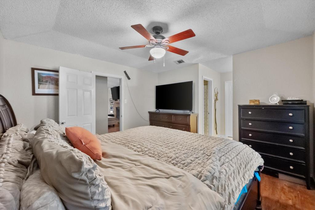 1312 Hackamore Street Mesquite, TX 75149 - Photo 23 of 28 a bedroom with a bed and a flat screen tv