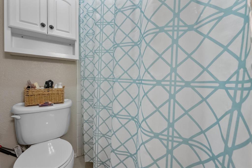 1312 Hackamore Street Mesquite, TX 75149 - Photo 25 of 28 a white toilet sitting next to a white wall