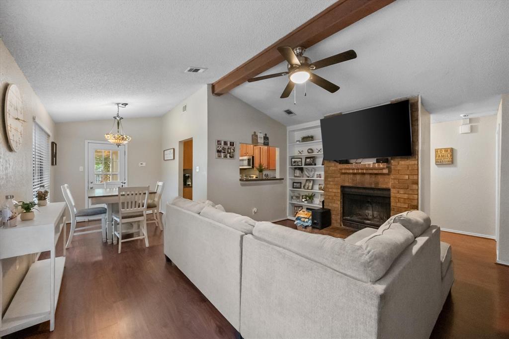 1312 Hackamore Street Mesquite, TX 75149 - Photo 5 of 28 a living room with furniture a fireplace and a flat screen tv