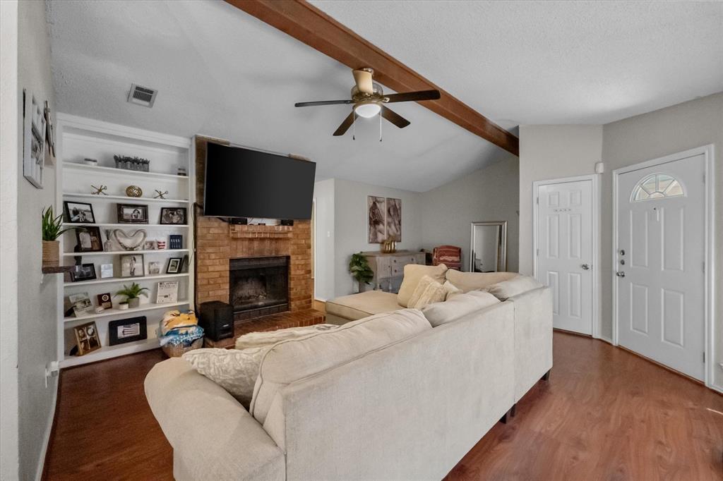 1312 Hackamore Street Mesquite, TX 75149 - Photo 6 of 28 a living room with fireplace furniture and a flat screen tv