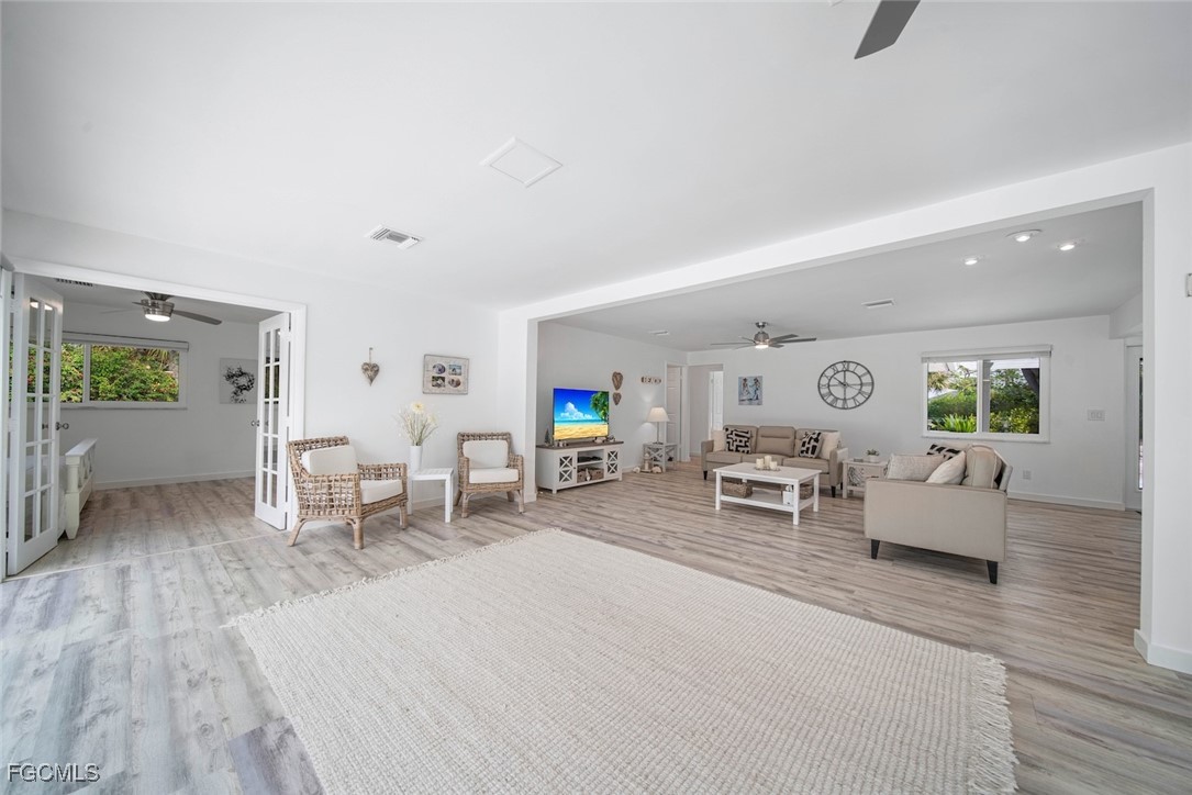 4639 Brainard Bayou Road Sanibel, FL 33957 - Photo 14 of 50 a living room with furniture and a wooden floor