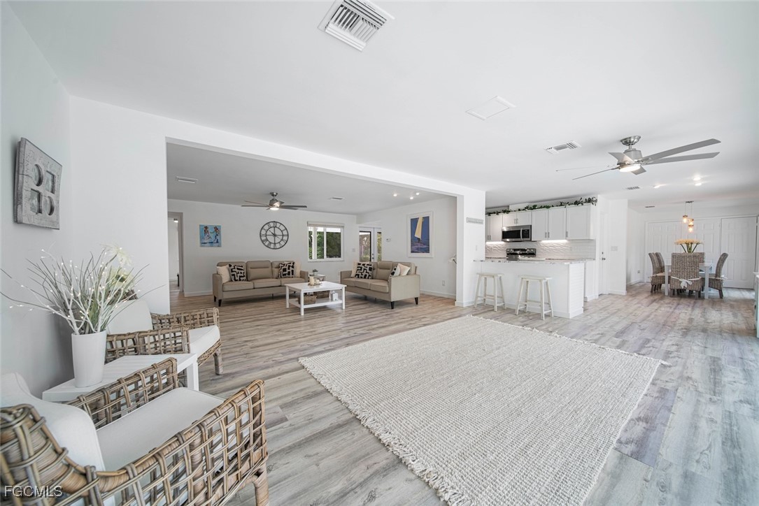 4639 Brainard Bayou Road Sanibel, FL 33957 - Photo 15 of 50 a living room with furniture and a wooden floor
