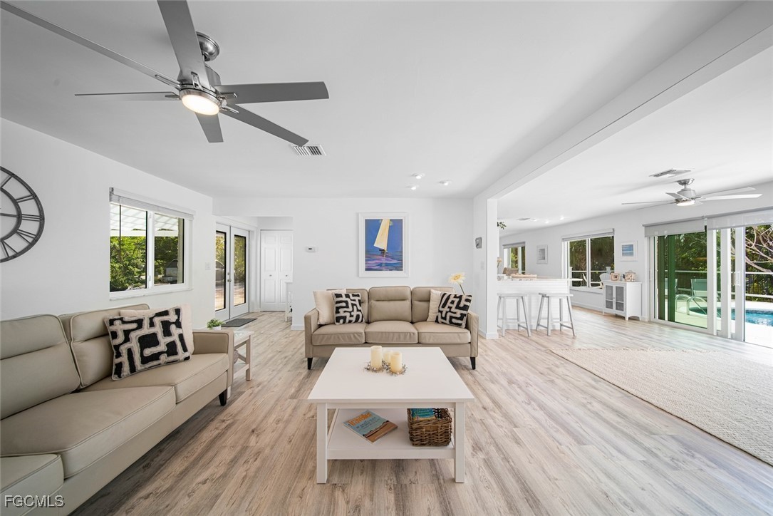 4639 Brainard Bayou Road Sanibel, FL 33957 - Photo 17 of 50 a living room with furniture white walls and a large window